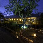 Toka Leya twinkles at night with lantern light and camp fire