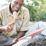 Carving a spear the traditional way at Bushman Plains Camp