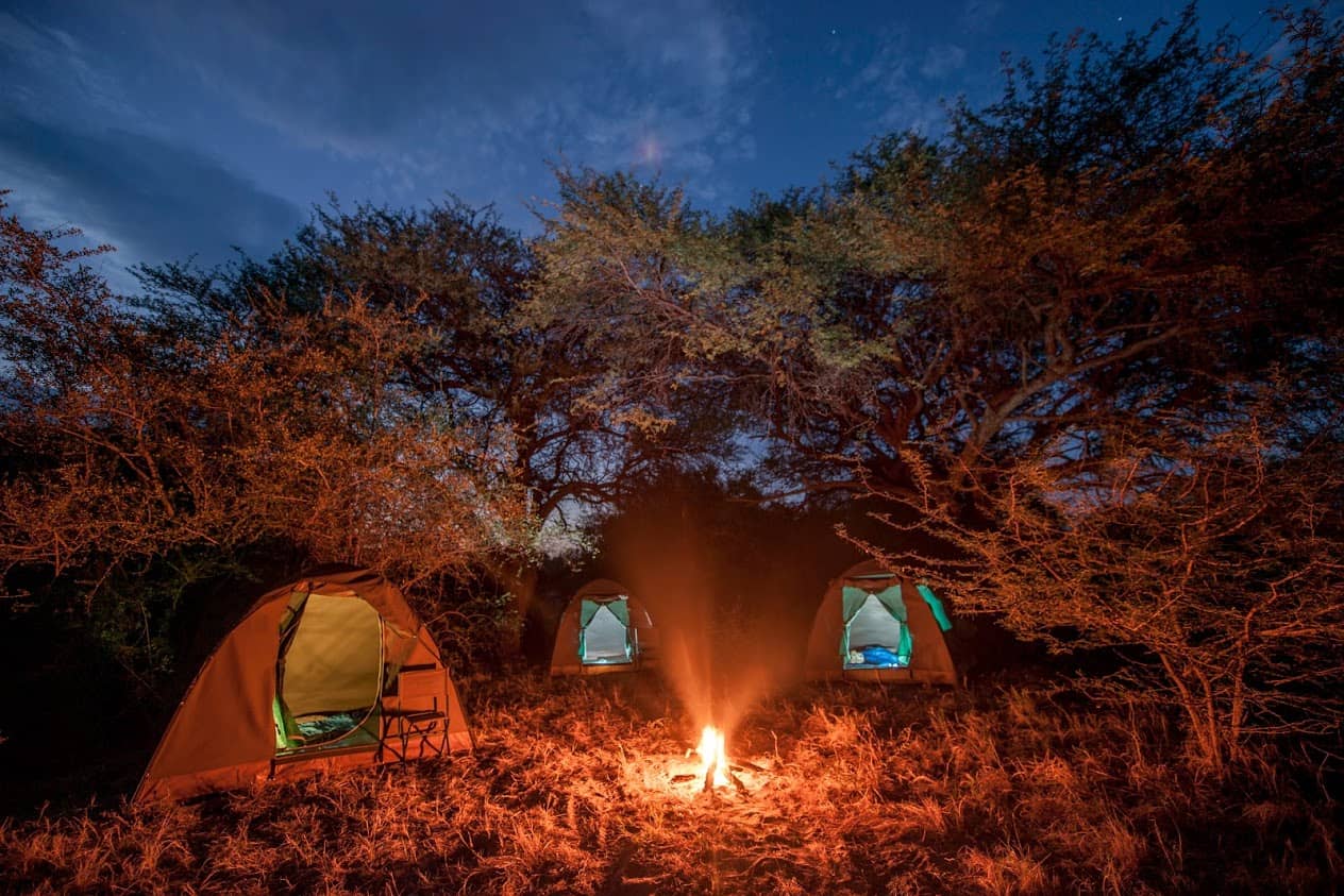 A bushways safari camp setup under the evening sky