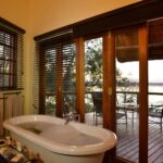 Freestanding luxury bath tub with view at Muchenje Safari Lodge