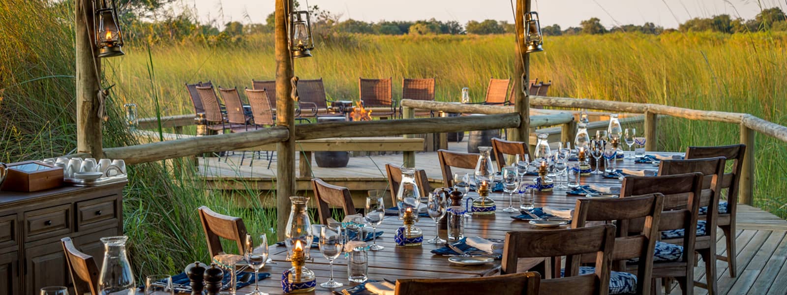 The perfectly located dining area at Little Vumbura set up for dinner s the sun starts to get lower in the sky