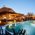 Motse front of lodge with free form swimming pool