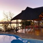 Muchenje pool deck with thatched eating area and loungers