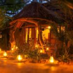 Thamo Telele Lodge entrance at night lit by lantern light