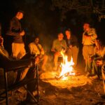 Guests sharing experiences around the camp fire at Bushman Plains Camp