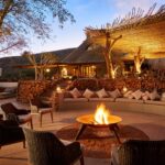 The Motse fire pit against luxury lodge backdrop