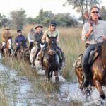 David Foot Safaris group gallop through the flood waters