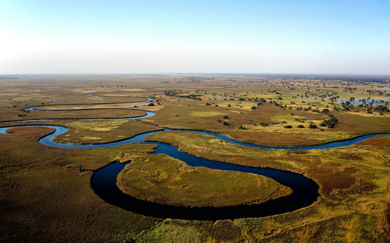 The Okavango River snakes through the Delta forming islands of greenery along the way