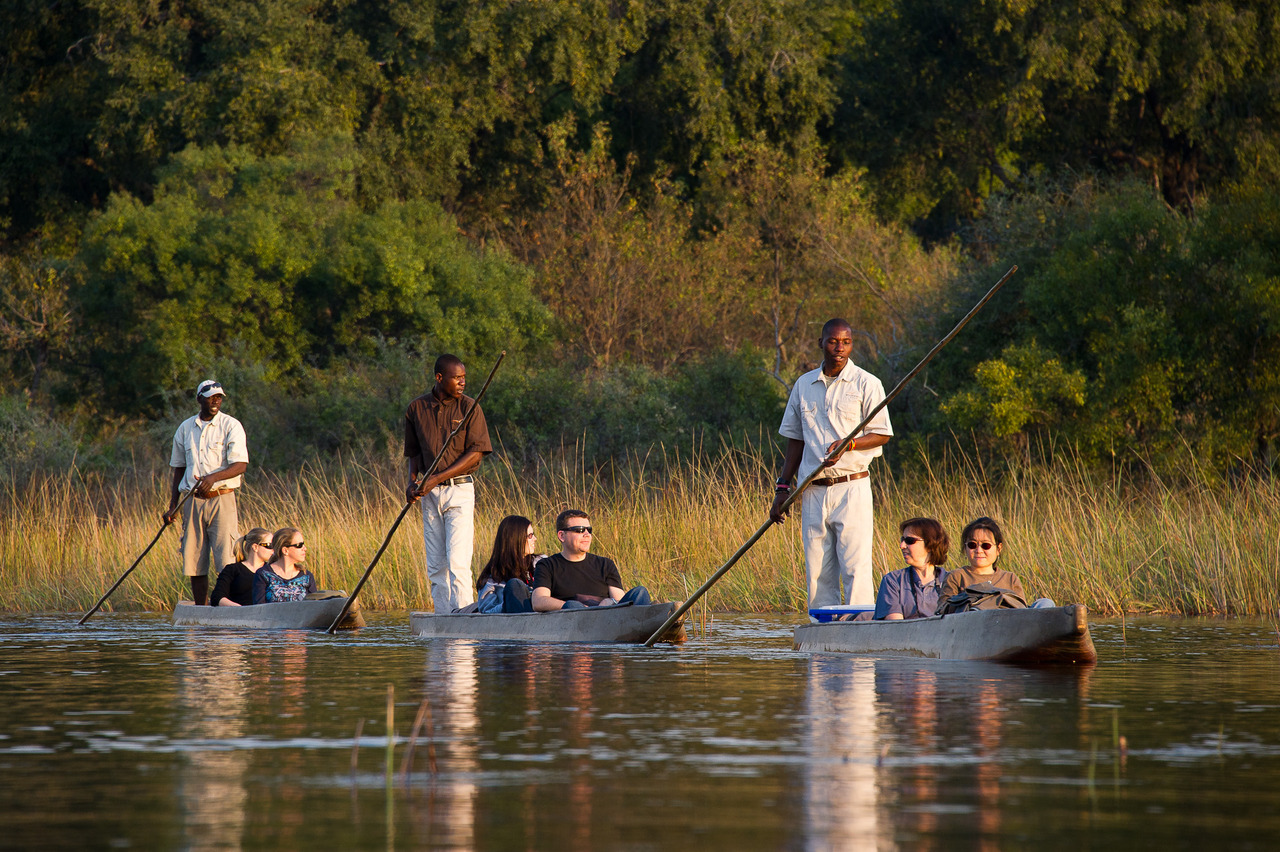 Tourism in the Okavango Delta depicted by mekoros in the water