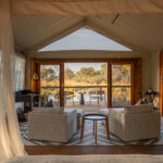 View from bed toward private deck overlooking the Okavango Delta at Four Rivers Camp.