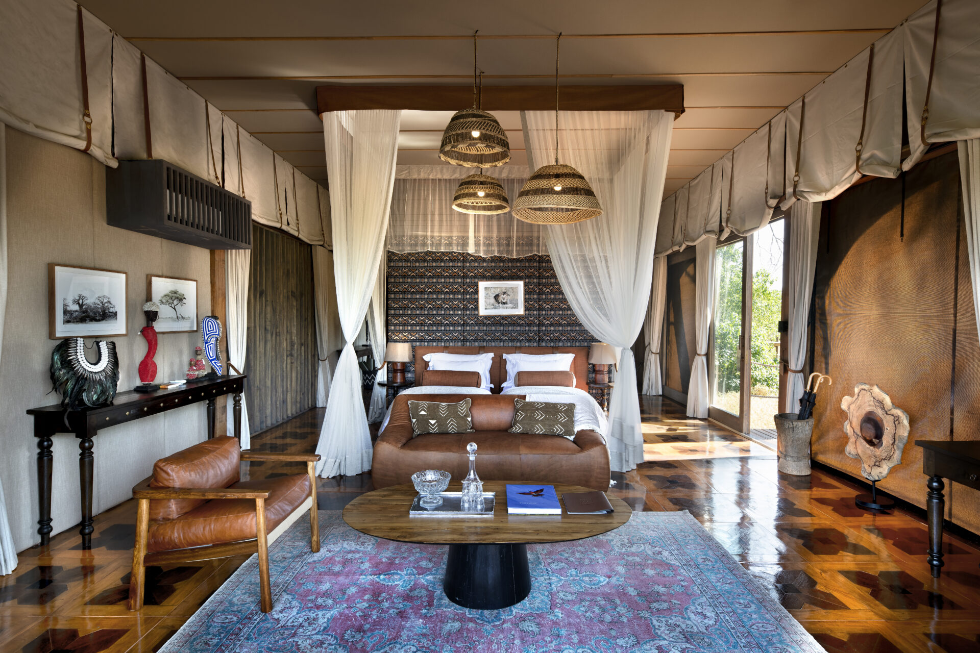 Atzaró Okavango Camp luxury bedroom suite with four-poster bed and refined decor in Botswana.