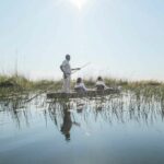 Exploring the Okavango water by traditional Mokoro at Maxa