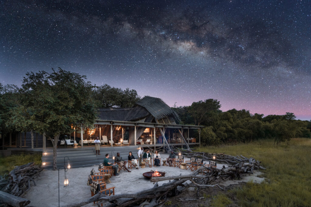 King Lewanika Lodge boma and main area illuminated under dramatic starry skies in Zambia