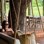 Guest relaxing in the main area lounge at Sediba Sa Rona safari camp