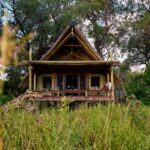 A gust relaxed on her private deck of a safari suite surrounded by okavango bush
