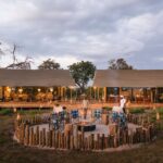 The firepit being lit at dusk in front of the main area at Nkasa Linyanti