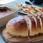 Freshly baked bread and homemade dishes served as part of a safari camp meal.