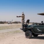 A warm welcome on landing at Sandibe Concession from your &Beyond guide and 4x4 game vehicle.